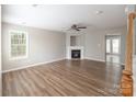 Bright living room with hardwood floors, a fireplace and a ceiling fan at 8432 Spirea Ct, Charlotte, NC 28215