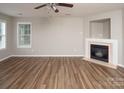 Living room with fireplace, ceiling fan, neutral color walls and hardwood floors at 8432 Spirea Ct, Charlotte, NC 28215