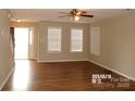 Spacious living room filled with natural light, laminate flooring, and neutral paint at 8432 Spirea Ct, Charlotte, NC 28215
