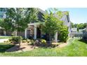 Beautiful single-Gathering home showcasing a manicured lawn, stone accents, and a welcoming front porch at 9062 Treetop Nw Way, Concord, NC 28027