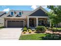 Charming single-Gathering home featuring a well-maintained front yard, stone accents, and an attached two-car garage at 9062 Treetop Nw Way, Concord, NC 28027
