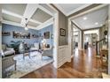 Formal living room showcasing tray ceilings, hardwood floors, large windows and decorative accents at 998 Emory Ln, Fort Mill, SC 29708