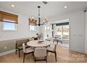 Charming dining area with a modern chandelier and an open view into the bright living room at 1042 Waxhaw Crossing Dr # 262, Waxhaw, NC 28173
