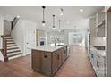 Open-concept kitchen with large island, modern lighting, and seamless flow to the living area at 1048 Waxhaw Crossing Dr # 261, Waxhaw, NC 28173