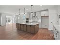 Spacious kitchen features white cabinetry, a large island with seating, and modern stainless steel appliances at 1048 Waxhaw Crossing Dr # 261, Waxhaw, NC 28173