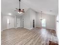 Bright living room with vaulted ceilings and hardwood floors showcasing the front door and staircase at 10736 Spruce Mountain Rd, Charlotte, NC 28214