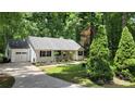 Inviting white home featuring front porch, attached garage, and a well-landscaped front yard at 109 Pepper Cir, Mooresville, NC 28117
