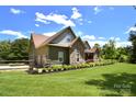 Beautiful exterior angle shows the home's lush landscaping and attached two-car garage at 114 Wingard Rd, Concord, NC 28025