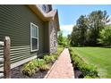 Beautiful walkway leading to the home featuring manicured landscaping and green lawn at 114 Wingard Rd, Concord, NC 28025