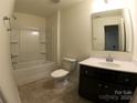 Bathroom with a vanity, toilet, and a shower-tub combo with tile surround at 120 Mooring Dr, Statesville, NC 28677