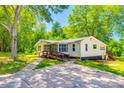 Charming house featuring a well-manicured lawn and welcoming wooden ramp for accessibility at 1224 Martin Rd, Hickory Grove, SC 29717