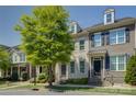 Street view of brick townhouses, showcasing manicured landscaping and traditional architectural style at 1225 Assembly St, Belmont, NC 28012