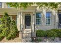 Charming brick townhouse featuring landscaped front yard, trimmed bushes, and a black front door at 1225 Assembly St, Belmont, NC 28012