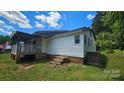 Quaint single story home with covered porch and side entry, showcasing rustic charm at 140 Dalu Ln, Harmony, NC 28634