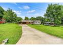 Spacious property featuring a well-maintained home, long driveway, and verdant lawn at 141 Porter Rd, Statesville, NC 28625