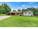 Inviting single-story home featuring a well-manicured lawn and classic curb appeal at 141 Porter Rd, Statesville, NC 28625