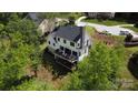 Expansive backyard featuring a two-level deck and lush greenery, perfect for outdoor entertaining at 1543 Withers Dr, Denver, NC 28037