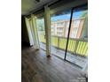 Bright living room with sliding glass doors to the deck with view of the yard at 1624 Arlyn Cir # G, Charlotte, NC 28213