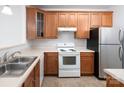A kitchen boasting wood cabinets, stainless steel refrigerator, and essential appliances at 17119 Doe Valley Ct, Cornelius, NC 28031