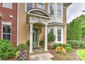 Inviting home entrance with a covered porch, manicured landscaping, and a stylish front door at 17210 Sulky Plough Rd # 1206, Charlotte, NC 28277