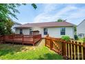 This cozy backyard features a wooden deck, grassy area and a wooden privacy fence at 1957 8Th Street Se Ln, Hickory, NC 28602