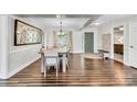 Bright dining room with wood floors, a large mirror, and a view to the entry foyer at 2005 Schofield Pl, Salisbury, NC 28144