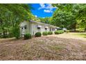 Charming single-story home with mature trees and manicured landscaping at 208 Lipe Rd, Troutman, NC 28166