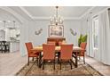Bright dining room featuring hardwood floors, elegant lighting and decor, and a view of the kitchen at 240 Bells Crossing Dr, Mooresville, NC 28117