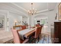 Bright dining room with decorative rug, open archway to living room, and modern lighting fixture at 240 Bells Crossing Dr, Mooresville, NC 28117