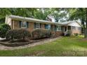Attractive brick home with blue shutters, showcasing well-manicured landscaping and a stone walkway at 2618 Pineview Dr, Lancaster, SC 29720