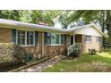 Inviting brick home featuring blue shutters and a charming entrance with a white-railed porch at 2618 Pineview Dr, Lancaster, SC 29720