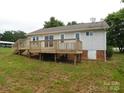 Expansive wooden deck in the backyard with access to the home and a view of the yard at 3001 Austin Chaney Rd, Monroe, NC 28110
