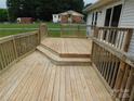 Well-maintained wooden deck featuring multiple levels and railings, ideal for outdoor enjoyment at 3001 Austin Chaney Rd, Monroe, NC 28110