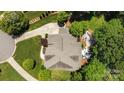 An aerial view of a well-maintained home with a backyard patio and lush greenery surrounding the property at 3009 Botetourt Ct, Matthews, NC 28104