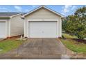 A detached one car garage with a white garage door and concrete driveway at 3013 Coventry Commons Dr, Mint Hill, NC 28227