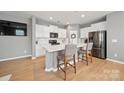 Modern kitchen with white cabinets, stainless steel appliances, and quartz countertops at 3013 Coventry Commons Dr, Mint Hill, NC 28227