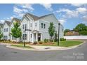 Well-manicured lawn surrounds this two-story home featuring a welcoming front porch in a vibrant neighborhood at 355 Ladybird Ln, Pineville, NC 28134