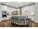 Bright kitchen with granite countertops, stainless steel appliances, and a kitchen island with barstool seating at 3808 Halcyon Dr, Huntersville, NC 28078
