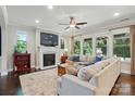 Cozy living room with a fireplace, tv, recessed lights, a ceiling fan, and lots of natural light at 3808 Halcyon Dr, Huntersville, NC 28078