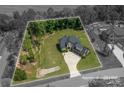 An aerial view of a home showcasing its expansive lot surrounded by mature trees at 4143 Willow Haven Dr, Denver, NC 28037