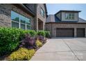 This home features a well-manicured lawn and an attached two-car garage at 4143 Willow Haven Dr, Denver, NC 28037