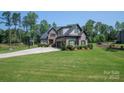Charming two-story brick home featuring a well-manicured lawn and a basketball hoop on a long driveway at 4143 Willow Haven Dr, Denver, NC 28037