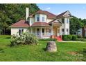 Inviting two-story home featuring a charming front porch and mature landscaping at 4499 Briarcreek Rd, Maiden, NC 28650