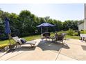 Spacious patio with outdoor seating, a grill, and lush greenery in the backyard, ideal for entertaining guests at 4683 Dunberry Sw Pl, Concord, NC 28027