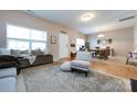 Cozy living room featuring a plush rug, comfortable seating, and natural light, creating a warm and inviting atmosphere at 4683 Dunberry Sw Pl, Concord, NC 28027