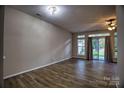 Spacious living room with new flooring and a sliding glass door leading to the outside at 4728 Cottage Oaks Dr, Charlotte, NC 28269
