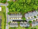 Aerial view of townhomes showing lot lines surrounded by lush trees in a well maintained community at 4848 Fonthill Ln, Charlotte, NC 28210