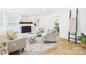 Charming living room with a brick fireplace, built-in shelving, and comfortable seating with warm natural light at 4905 Chestnut Lake Dr, Charlotte, NC 28227