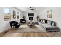Bright living room with a decorative fireplace, modern furniture, and large windows offering great natural light at 5520 Chestnut Dr, Hickory, NC 28602