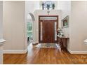 Grand foyer boasts gleaming hardwood floors, soaring ceilings, and elegant details at 5812 Morgan Park Dr, Monroe, NC 28110